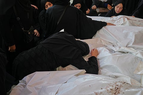 Mourners attend the funeral of their relatives who were killed in an Israeli bombardment, in Deir al-Balah, Gaza Strip, Saturday, July 12, 2025
