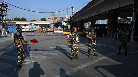(L) This screengrab shows Jammu and Kashmir Chief Minister Omar Abdullah climbing a fence to pay tribute to July 13 martyrs at Naqshband Sahib graveyard in the Old City of Srinagar. (R) Omar Abdullah, National Conference (JKNC) chief Farooq Abdullah and others pay tribute to July 13 martyrs at Naqshband Sahib graveyard