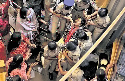 Police removing BJP women councillors who were protesting on the Mayor’s dais delaying the council meeting in the city corporation