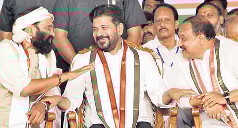 Chief Minister A Revanth Reddy shares a lighter moment with Irrigation Minister 
N Uttam Kumar Reddy and TPCC chief Mahesh Kumar Goud during the ration card distribution programme in Suryapet district on Monday