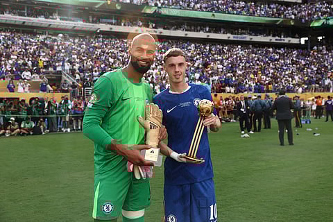 Chelsea's Robert Sanchez, left, holds the golden glove trophy as Cole Palmer holds the golden ball trophy after Chelsea won against PSG in the Club World Cup final on July 13, 2025.