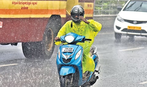  A motorists seen braving through rain in Chennai