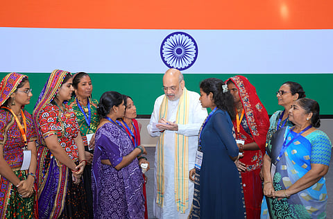 Union Home Minister Amit Shah interacts with women from Gujarat, Madhya Pradesh, and Rajasthan and other cooperative workers associated with the cooperative sector during 'Sahkar Samvaad' programme in Ahmedabad, Gujarat, in Ahmedabad on Wednesday.