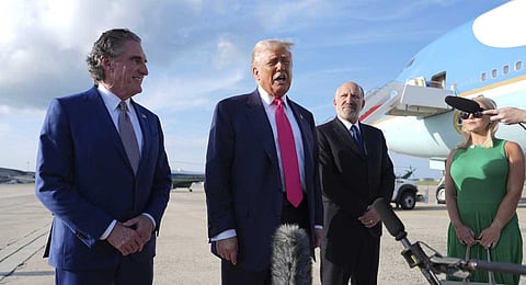 President Donald Trump speaks to the media after arriving at Joint Base Andrews, Tuesday, July 15, 2025, in Joint Base Andrews, Md., as Secretary of the Interior Doug Burgum, left, Secretary of Commerce Howard Lutnick and White House Press Secretary Karoline Leavitt, right, look on. 
