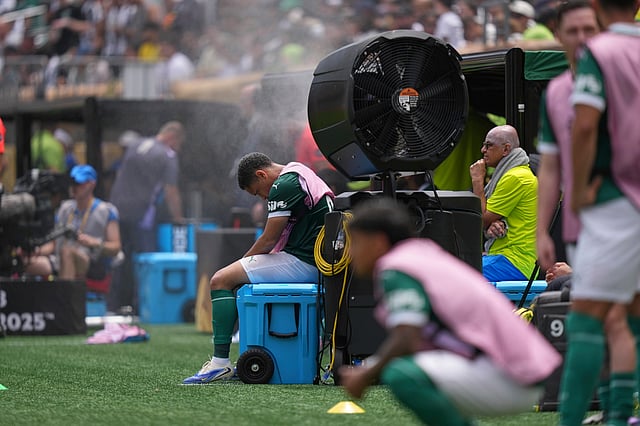 Palmeiras' Vitor Roque sits on the side of the pitch in a cooling mist after being substituted during the Club World Cup round of 16 soccer match between Palmeiras and Botafogo in Philadelphia, Sunday, June 29, 2025.