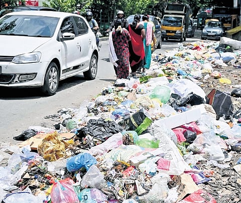 Garbage thrown on the pavement near Kadirenahalli underpass has forced pedestrians to walk on the road, dangerously close to traffic.