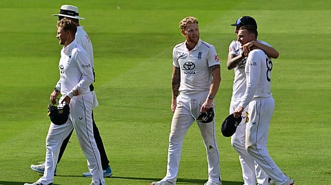 England's captain Ben Stokes (C) and England's Brydon Carse (R) walk back to the pavilion as England win the test match on the fifth day of the third cricket test match between England and India at Lord's cricket ground in London, on July 14, 2025. 