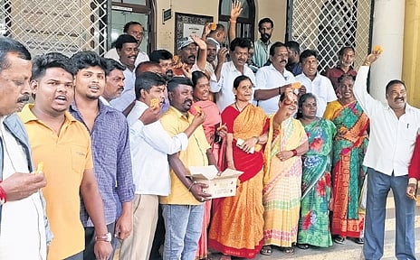 Pourakarmikas celebrate in front of the MCC office in Mysuru on Thursday