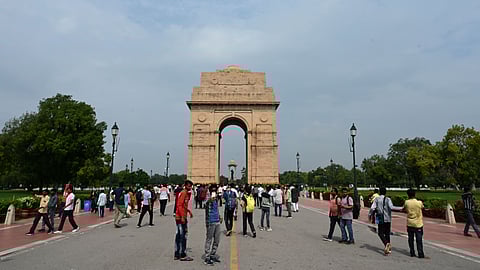 People visit the lawns of the Kartavya Path near India Gate on July 16, 2025, in New Delhi, as authorities ban picnics and eatables around Central Vista, maintaining appearance.