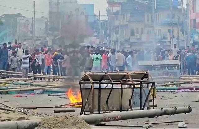 In this image made from a video, supporters of the ousted Prime Minister Sheikh Hasina clash with the police in Gopalganj, Bangladesh, Wednesday, July 16, 2025.