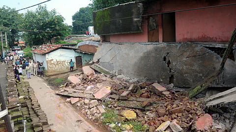  Locals gather after a portion of the roof of a government school building collapsed, in Ranchi, Friday, July 18, 2025. One person was killed and another feared trapped in the incident.