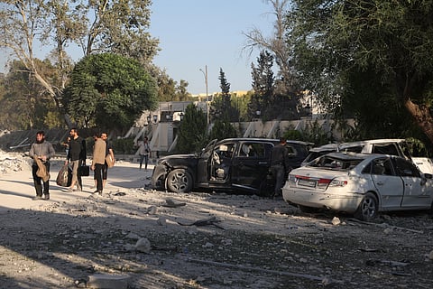 Bedouin fighters gather in front a burned shop at Mazraa village on the outskirts of Sweida city, during clashes between the Bedouin clans and Druze militias, southern Syria, Friday, July 18, 2025.