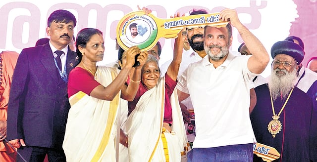 Congress leader Rahul Gandhi presenting the keys of the house built by Oommen Chandy Foundation to a beneficiary in Puthuppally on Friday