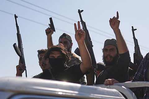 Bedouin fighters stand on a pickup truck as they arrive at al-Dour village on the outskirts of Sweida city, during clashes between the Bedouin clans and Druze militias, southern Syria, Friday, July 18, 2025. 
