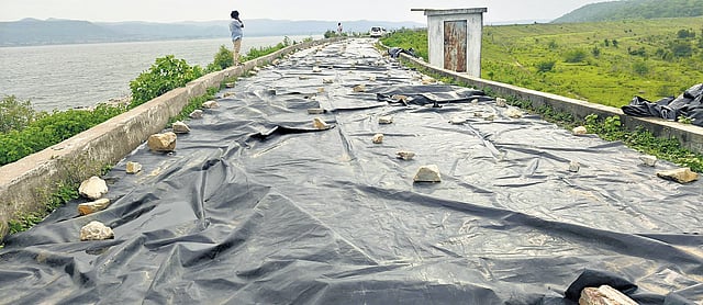 A portion of Kumuram Bheem project (Ada project) covered with plastic sheets following damage to its sidewall