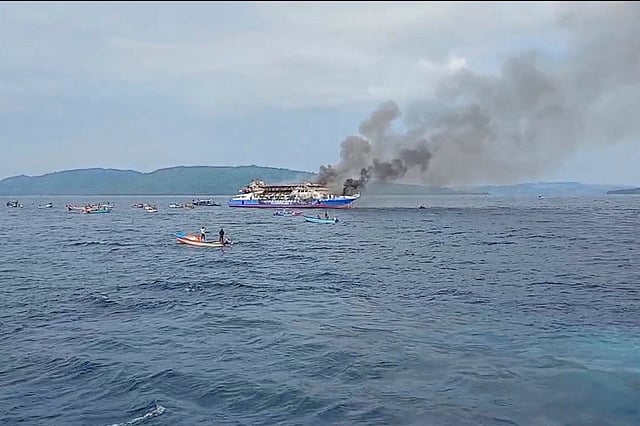 In this photo made from video released by the Indonesian National Search and Rescue Agency (BASARNAS), smoke billows from passenger ship KM Barcelona after it caught fire in the waters off Talise Island in North Sulawesi, Indonesia, Sunday, July 20, 2025.