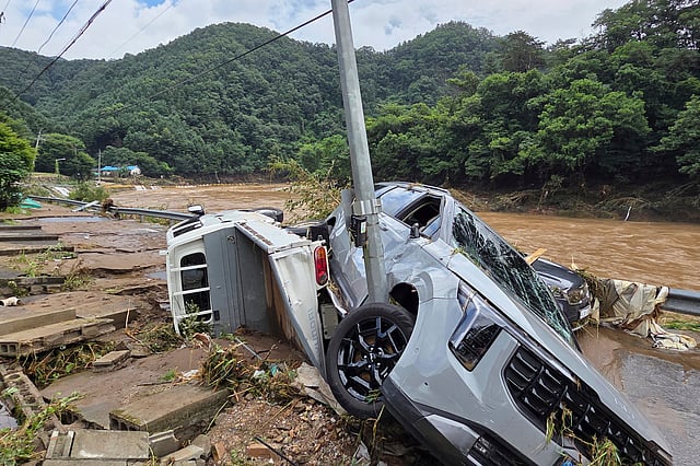Damaged vehicles are seen after heavy rains in Gapyeong, South Korea, Sunday, July 20, 2025