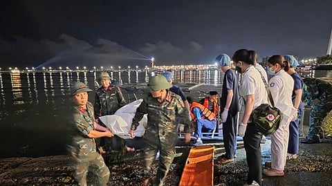 This image from a video provided by QDND shows a body being carried on stretcher after a tourist boat capsized in Ha Long Bay, Vietnam on Saturday, July 19, 2025.