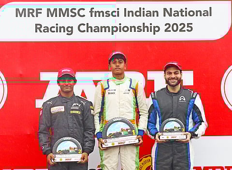 MRF F2000 Race-2 winner Ishaan Madesh (centre), second-placed Arjun Chheda (left) and third-placed Akhil Agarwal pose with trophies on Sunday