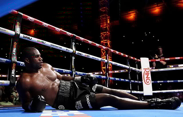 Daniel Dubois lies on the ring after a knockout by Ukraine's Oleksandr Usyk during their world heavyweight boxing title fight, in London, Saturday, July 19, 2025.