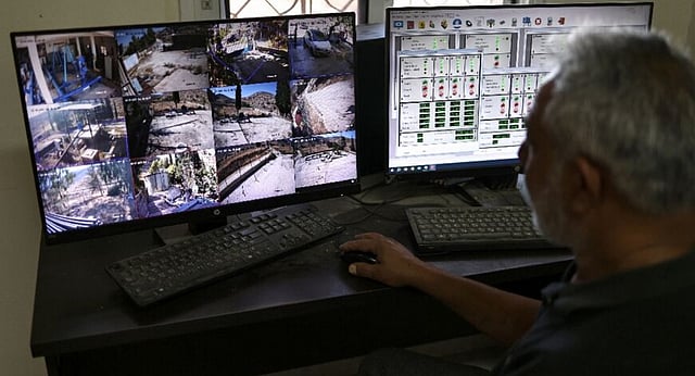 Subhil Olayan, a water pump operator, monitors screens at the pumping station near the Ein Samiyah spring near the village of Kafr Malik, in the Israeli-occupied West Bank, on July 15, 2025. 