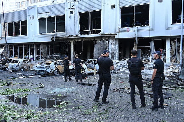 Police officers inspect damaged cars at a residential area following Russia's drone attack in Odesa, Ukraine, Tuesday, July 22, 2025.