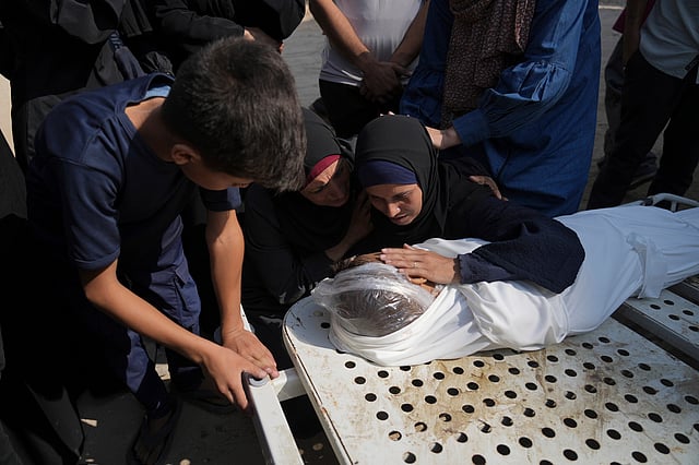 Relatives of Palestinian child Salem Hussein, 12, killed in an Israeli army bombardment of Gaza, mourn beside his body at Shifa Hospital in Gaza City on Tuesday, July 22, 2025.