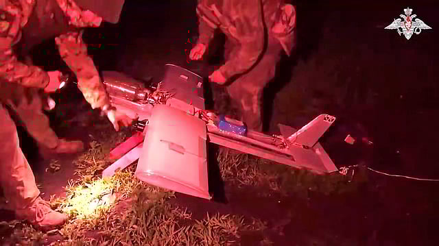 In this photo taken from video distributed by Russian Defense Ministry Press Service on July 18, 2025, Russian soldiers prepare a strike drone aircraft to fly toward Ukrainian positions in an undisclosed location.