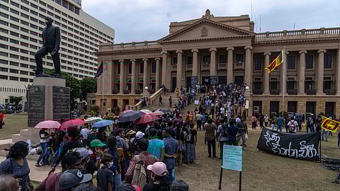 In this photo from July 11, 2022, protesters throng then-President Gotabaya Rajapaksa's official residence for the second day after it was stormed in Colombo.