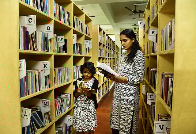 A woman and her daughter browse through books at EMS Library