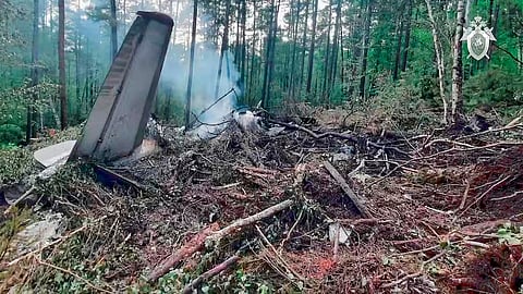 In this photo taken from video released by Russian Investigative Committee on Thursday, July 24, 2025, a view of the place of the crashed Russian An-24 passenger plane of the Siberia-based Angara Airlines while carrying 49 passengers in 15 kilometers (9 miles) south of Tynda, Far Eastern Amur region of Russia.