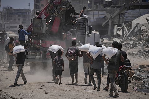 Maysara Adwan, left, mourns as she holds the body of her 11-year-old son, Qais,