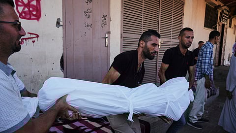 Mourners carry the body Ibrahim Al-Khatib who was killed in an Israeli bombardment of Al-Zawaideh, central Gaza Strip, Thursday, July 24, 2025