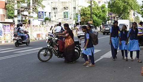 Students having a tough time crossing Thillai Nagar main road.