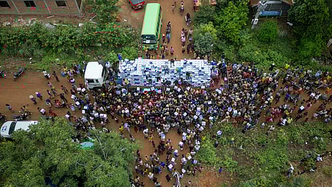 Displaced Cambodians receive water at the Battkhao Resettlement Camp in Oddar Meanchey Province, Cambodia, Saturday, July 26, 2025.