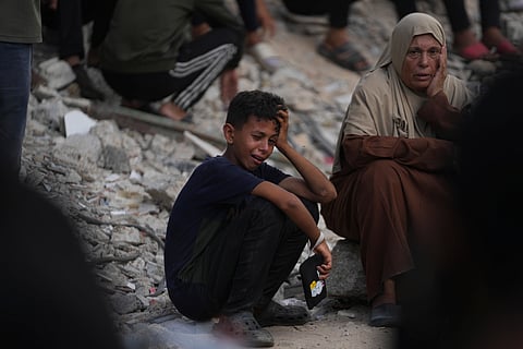 Marwa Barakat, center, mourns during the funeral of her son Fahd Abu Hajeb, 36, who was killed while trying to reach aid trucks entering northern Gaza through the Zikim crossing with Israel, at Shifa Hospital, in Gaza City, Saturday, July 26, 2025.