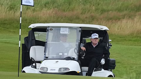 President Donald Trump steers a golf cart at the Trump Turnberry golf course in Turnberry, Scotland, Saturday, July 26, 2025
