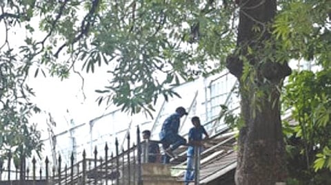 Teenagers seen climbing through a broken boundary near the railway tracks at Public Garden, Nampally 
