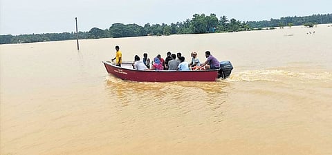 Women collect water from a submerged tube-well in a village under Baliapal block.
