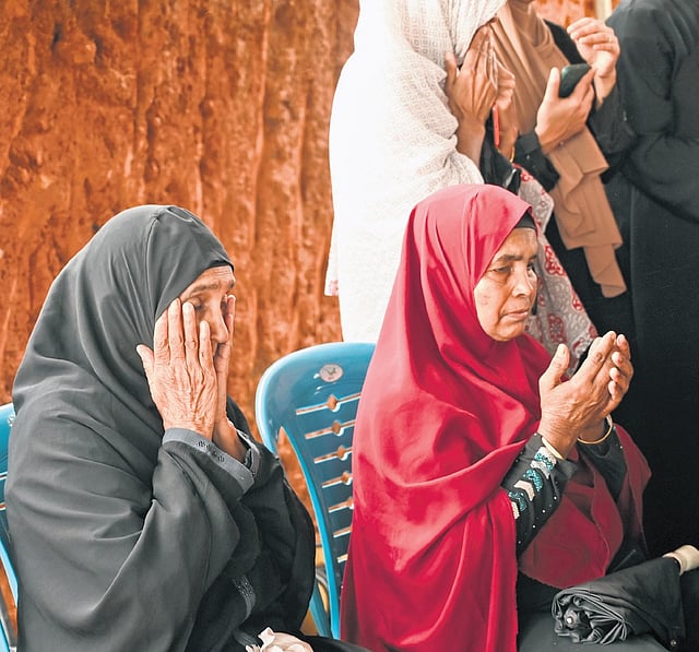 Women weep during a prayer meet organised by IUML at the Puthumala 
burial ground on Tuesday.