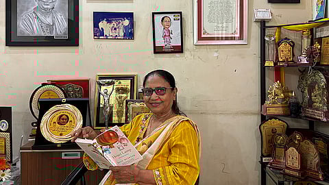 Banu Mushtaq posing with the book Heart Lamp at her residence in Hassan, Karnataka 