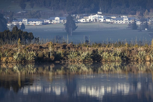 The Gloriavale Christian Community, near Haupiri New Zealand, is reflected in water on July 2, 2020.