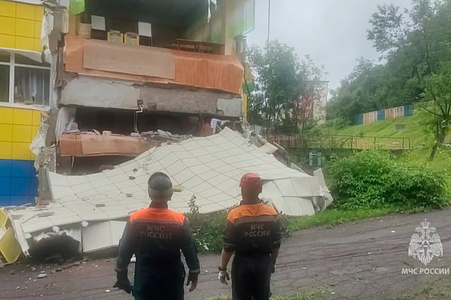 In this image taken from a video released by the Russian Emergency Ministry Press Service, rescuers inspect a kindergarten damaged by an earthquake in Petropavlovsk-Kamchatsky, Russia, Wednesday, July 30, 2025.