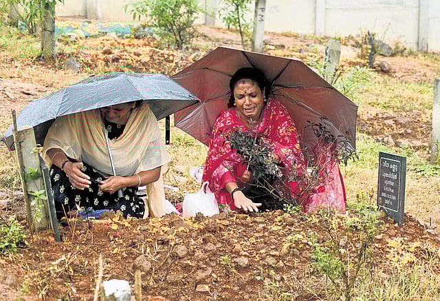 Chooralmala native sisters Ajitha and Ambika praying at their mother’s grave