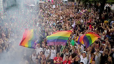 People dance as they take part in the LGBTQ annual pride march in Berlin, Germany, Saturday, July 26, 2025.