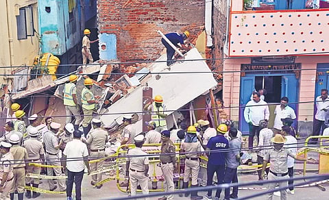 Police and emergency personnel cordon off the collapsed 80-year-old building to remove the debris at Sampangiram Nagar on Thursday.