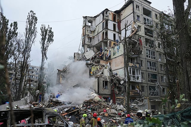 Rescuers work in a destroyed apartment building after a Russian missile attack in Kyiv, Ukraine, Thursday, July 31, 2025