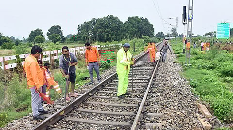 Railway staff carry out restoration and repair work of a railway track.