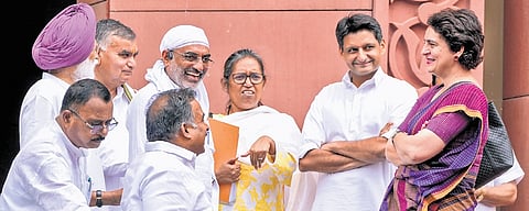 Congress MPs Priyanka Gandhi Vadra, Deepender Hooda and Varsha Gaikwad with others during the Monsoon session of Parliament on Friday.