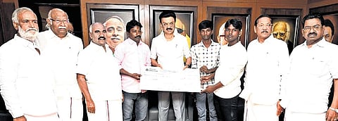 Chief Minister MK Stalin giving a cheque for `10 lakh to the family of a DMK functionary who was killed in an accident, in Chennai on Saturday.